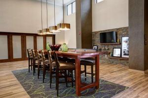 a dining room with a wooden table and chairs at Hampton Inn & Suites By Hilton Baltimore/Aberdeen, Md in Aberdeen