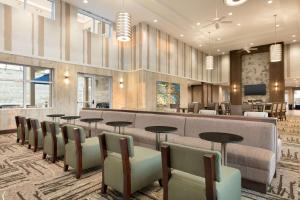 a lobby with a waiting area with tables and chairs at Homewood Suites By Hilton Hartford Manchester in Manchester