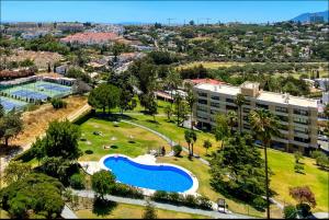 an aerial view of a park with a swimming pool at luxury golden sunset apartment Aloha puerto banus in Marbella