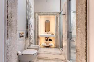 a bathroom with a toilet and a sink at Eitch Borromini Palazzo Pamphilj in Rome