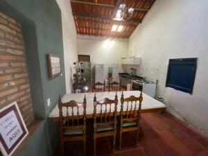 a kitchen with a table and chairs in a room at Solar dos Pássaros in Pacoti