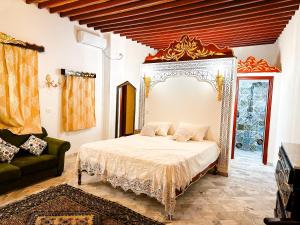 a bedroom with a bed and a couch in it at Dar Badiaa in Sousse