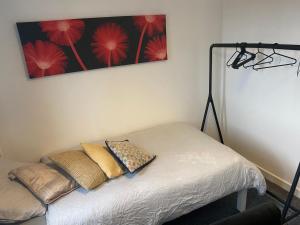 a bed in a room with a picture on the wall at bnb81 in Belfast