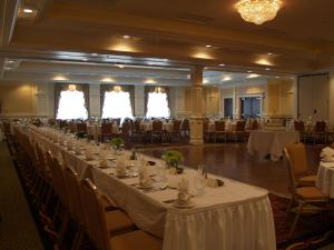 a long table in a banquet hall with tables and chairs at Hilton Garden Inn Bangor in Bangor