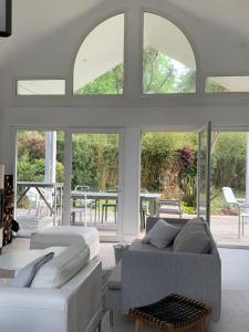 a living room with two beds and a couch at maison bleue in Biscarrosse