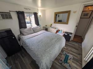 a small bedroom with a bed and a mirror at 2 Great room for rent, Individual entrance, Share bathroom, beautiful lake, in manufactured home 5 min from Hard Rock Hotel Casino in Davie