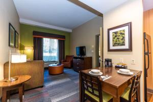 a living room with a table and a dining room at Homewood Suites by Hilton Birmingham-SW-Riverchase-Galleria in Hoover