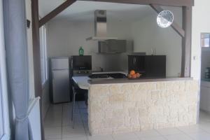 a kitchen with a counter and a counter top in a room at Maison Au Milieu De La Foret in Labastide-Rouairoux