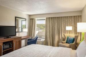 a hotel room with a bed and a tv and a window at Hampton Inn Birmingham-Trussville in Trussville