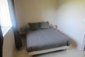 a small bedroom with a bed in a room at Maison Au Milieu De La Foret in Labastide-Rouairoux