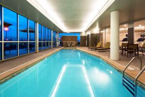 a swimming pool with blue water in a building at DoubleTree by Hilton West Fargo Sanford Medical Center Area in Fargo