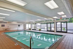 a large swimming pool with blue water in a building at Hampton Inn Bloomsburg in Bloomsburg