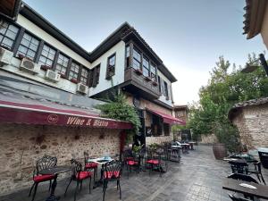 un patio con mesas y sillas frente a un edificio en Grace Lounge Suite, en Antalya