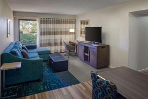 a living room with a couch and a tv at Hampton Inn & Suites Nashville-Airport in Nashville