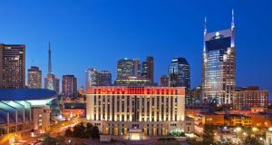 a city skyline at night with a large building at Hilton Nashville Downtown in Nashville