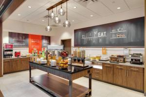 a restaurant with a counter with food on it at Hampton Inn & Suites by Hilton Nashville North Skyline in Nashville