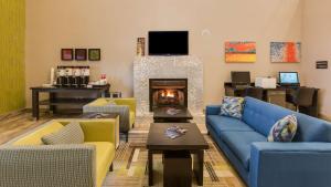 a living room with blue couches and a fireplace at Hampton Inn White House in White House