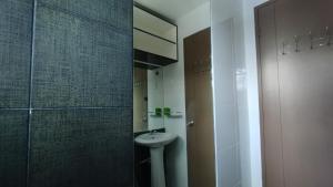 a bathroom with a sink and a glass shower at 2 Bedroom House in Bambu Estates Mintal Near Vista Mall and UP Mindanao in Davao City +24 photos