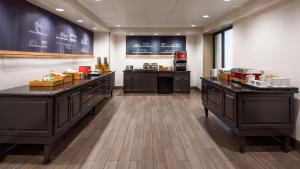 a restaurant with counters and a kitchen with at Hampton Inn & Suites Banning/Beaumont in Banning