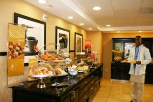 a man standing in front of a buffet of food at Hampton Inn & Suites Banning/Beaumont in Banning