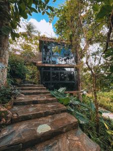 a set of stairs leading to a building in the forest at Taino Beach Lofts in El Valle