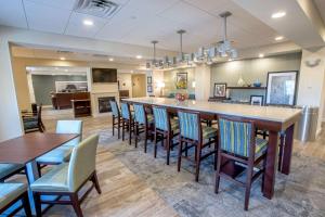 a large room with a bar with chairs and tables at Hampton Inn by Hilton Amesbury, MA in Amesbury