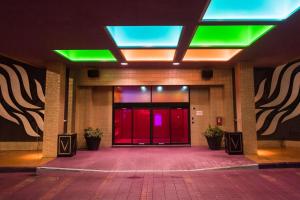 a lobby with a red door and green lights at The Verve Boston Natick, Tapestry Collection by Hilton in Natick
