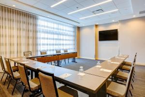 a conference room with a long table and chairs at Hampton Inn & Suites Boston/Waltham in Waltham +42 photos