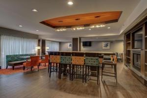 a living room with a bar and a dining room at Hampton Inn Bowie in Bowie