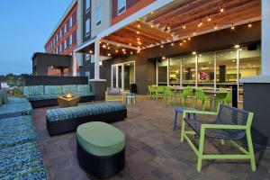 a patio with couches and chairs and a tables and chairs at Home2 Suites By Hilton Port Arthur in Port Arthur