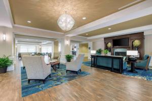 a lobby with a waiting area with chairs and a table at Hampton Inn & Suites Jekyll Island in Jekyll Island