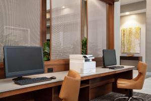 an office with a desk with a computer and a chair at Embassy Suites Brunswick in Brunswick