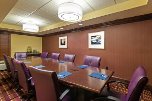 uma sala de conferências com uma mesa longa e cadeiras roxas em Hampton Inn I-10 & College Drive em Baton Rouge