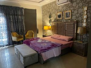a bedroom with a bed and a table and chairs at Three Bedroom Villa in Lahore