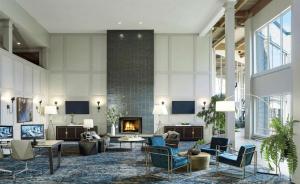 a lobby with a fireplace and couches and chairs at DoubleTree by Hilton Hotel Burlington Vermont in Burlington