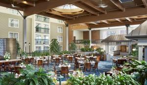 a restaurant with tables and chairs in a building at DoubleTree by Hilton Hotel Burlington Vermont in Burlington