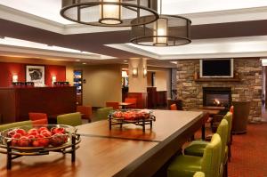 a dining room with a table and a fireplace at Hampton Inn Burlington - Colchester in Burlington