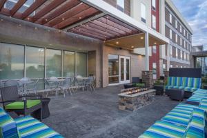 a patio with a table and chairs and a fire pit at Home2 Suites By Hilton Bowling Green in Bowling Green