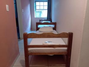 a small room with a bed and a window at Hospedaria Mineira Hostel Pousada in Ouro Preto