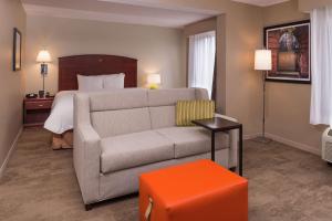 a living room with a couch and a bed at Hampton Inn Columbia Northeast-Fort Jackson Area in Columbia