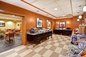 a waiting room at a restaurant with tables at Hampton Inn Chicopee - Springfield in Chicopee