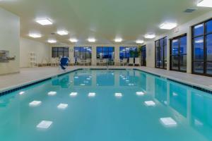 a large swimming pool with blue water in a building at Hampton Inn Clearfield in Clearfield