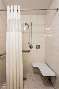 a bathroom with a shower with a white shower curtain at Hampton Inn Clearfield in Clearfield
