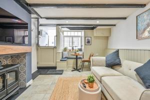 a living room with a couch and a table at Luxury Couple's Getaway with River Views and Parking in Polperro