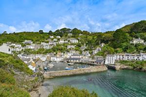 a town on a hill with boats in the water at Luxury Couple's Getaway with River Views and Parking in Polperro