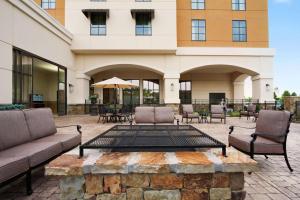 a patio with couches and chairs in front of a building at Embassy Suites Chattanooga Hamilton Place in Chattanooga