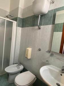a bathroom with a toilet and a sink at Guest House Pitagora in Rome