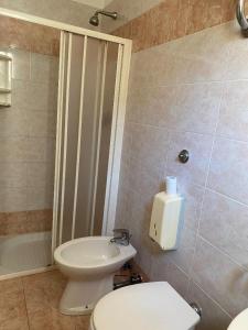 a bathroom with a toilet and a sink and a tub at Guest House Pitagora in Rome