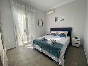 a bedroom with a large bed with blue pillows at Dimofontas - Hub Thiseio & Gkazi in Athens