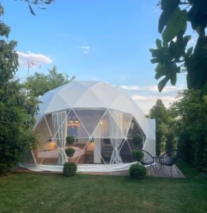 a large white tent in a yard at Ellie's Eco Private Glamping and Spa in Nea Kallikrateia